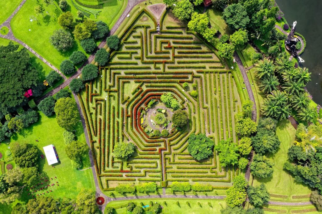 Stunning aerial shot of a botanical maze garden with lush greenery in Sukaresmi, Indonesia.